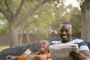 Father and son laughing and reading | Melissa Graham-Hurd & Associates